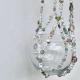 A soft-focused image showing the delicate fusion of soft greens and neutral tones in the Antique Garden beaded hanger.