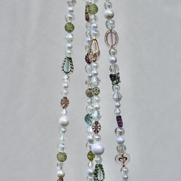 The Antique Garden beaded plant hanger styled in a room, adding old-world beauty to the home decor.