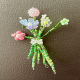 Macro shot displaying the intricate beadwork and whimsical floral design of a unique artisan magnet.