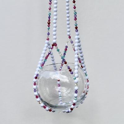The complete Berry Frost beaded plant hanger, a colorful home decor accent with vibrant jewel tones.