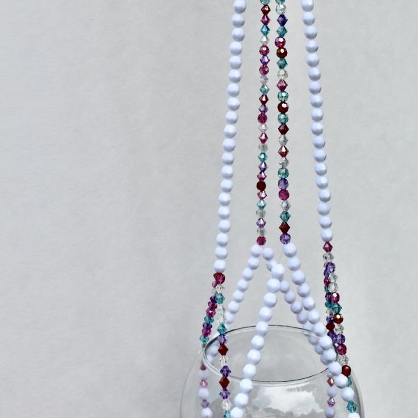 The vibrant Berry Frost plant hanger styled as a maximalist decor piece in a sunny room.