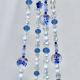 The full Blue Delft Bloom beaded plant hanger, showcasing its classic blue and white coastal charm.