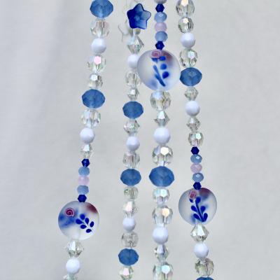 The full Blue Delft Bloom beaded plant hanger, showcasing its classic blue and white coastal charm.