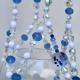 A close-up of the hand-painted floral glass beads and milky white accents on this porcelain-inspired plant hanger.