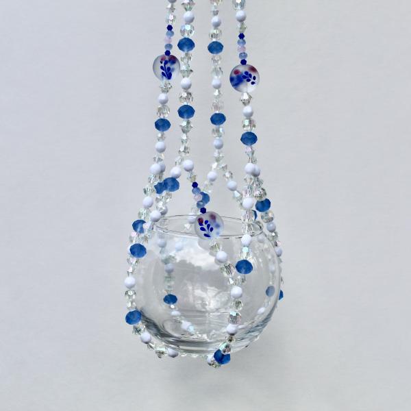 A detail shot of the cool blue and clear iridescent beads that give this handmade decor piece its sparkle.