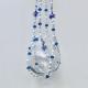 A detail shot of the cool blue and clear iridescent beads that give this handmade decor piece its sparkle.