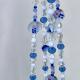The Blue Delft Bloom hanger styled as an elegant, handcrafted character piece for a plant display.