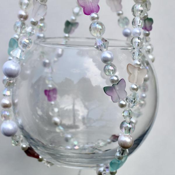 A detail shot of the handcrafted beadwork, celebrating nature with a soft and sweet pastel color palette.