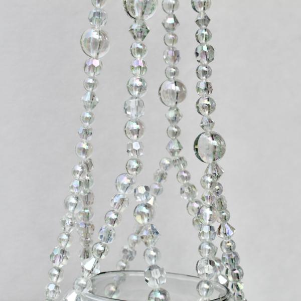 This handmade iridescent plant hanger acting as a beautiful light catcher in a sunny window.