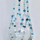This handmade beachy plant hanger styled as a serene statement piece for a bathroom or sunroom.