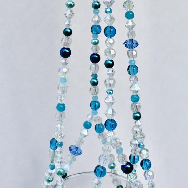 A detail shot capturing the calming essence of the sea in the handcrafted beadwork.