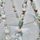 Detail shot focusing on the calming green and sand-colored beads of this ceramic-inspired piece.